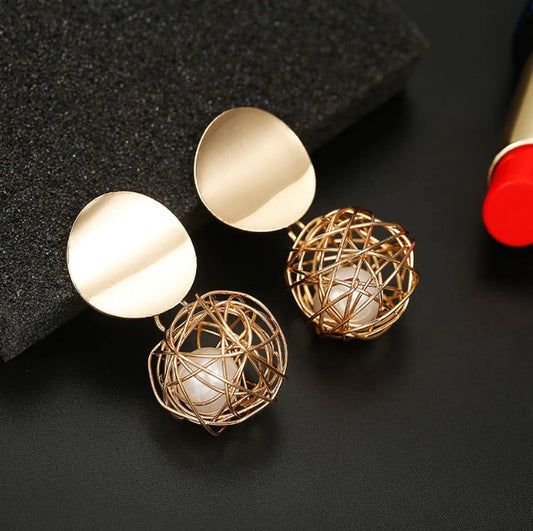 Boucles d'oreille d'inspiration ethnique: Nid de perle